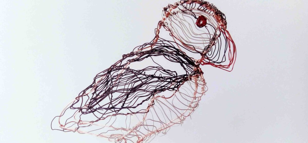 A sculpture of a puffin made out of wire.
