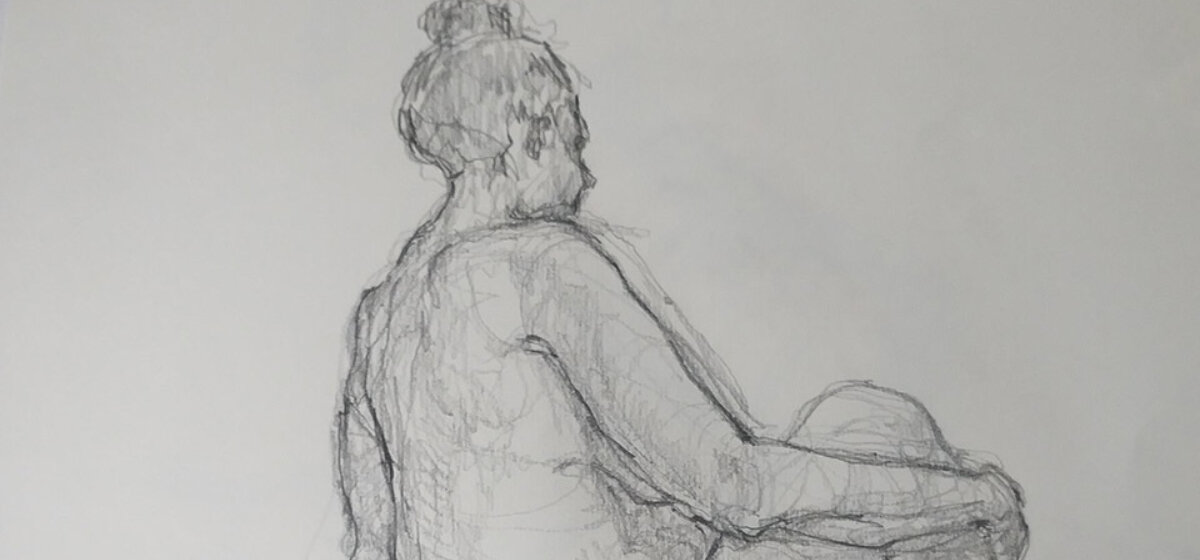 A figure of a woman drawn using a pencil on white paper.