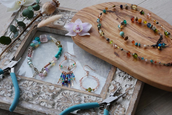 A collection of beaded jewellery and plyers