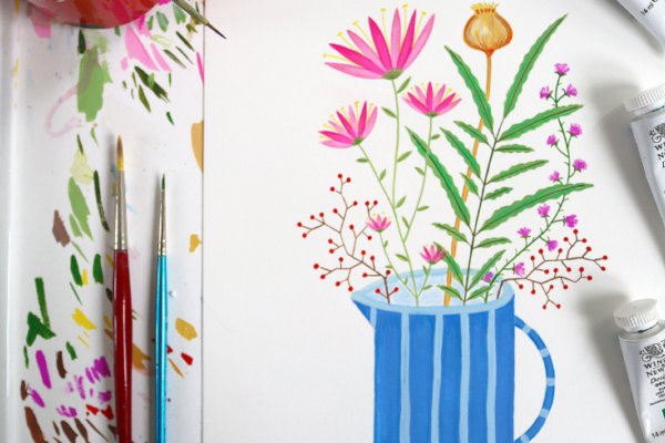 An image of a painted jug of flowers. On the left of the painting there are two paintbrushes with tested paint and on the right there are tubes of gouche paint in green and blue.