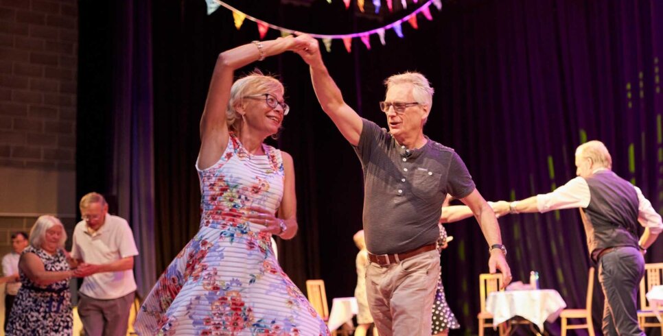 Two older people are dancing.
