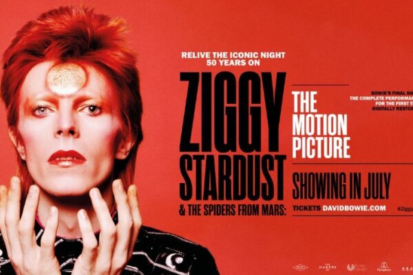 David Bowie pictured with red hair and gold make up on a poster that reads, Ziggy Stardust and the Spiders From Mars, the Motion Picture.