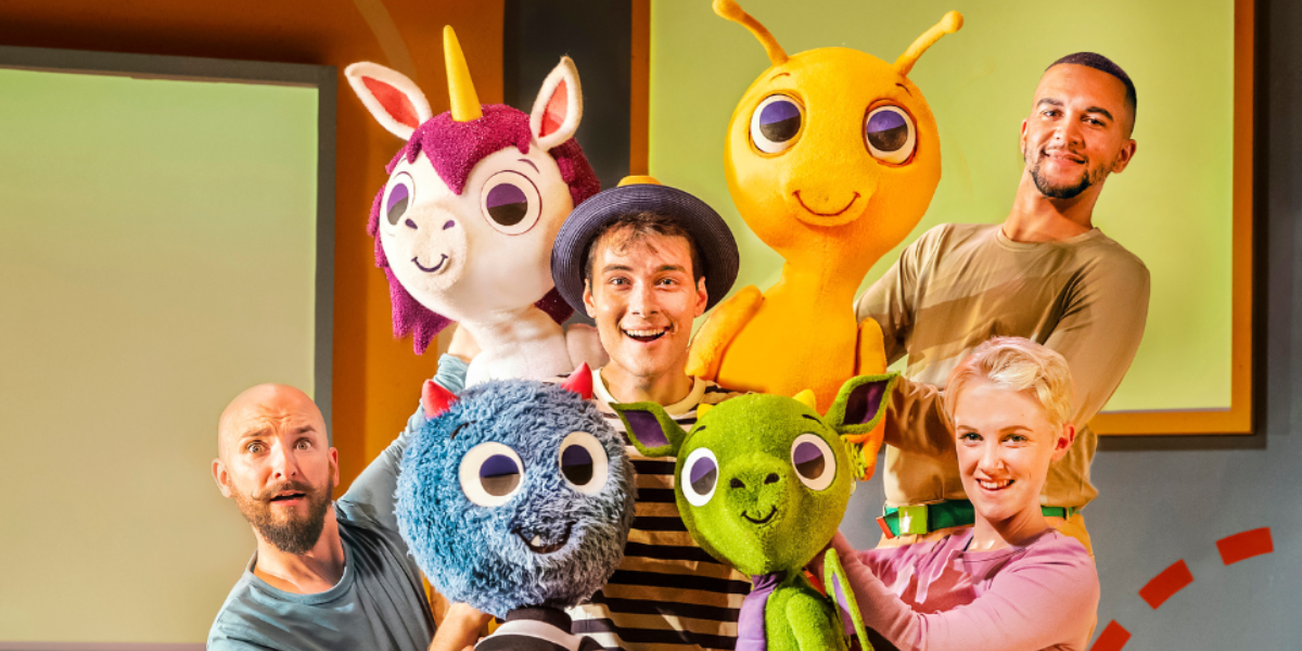 The cast and puppets of There's a Monster in Your Show. Monster, Unicorn, Alien and Dragon