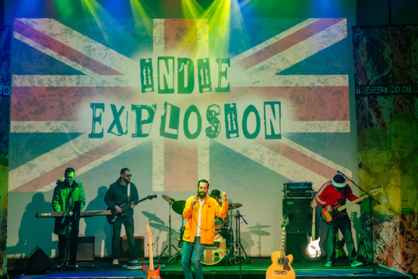Indie Explosion onstage with British flag behind them