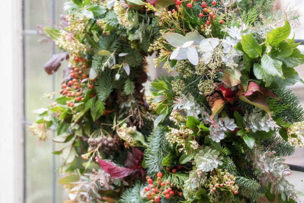 An up close image of Christmas Wreath with flowers.