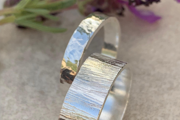 A spiral silver hammered ring by a lavender plant