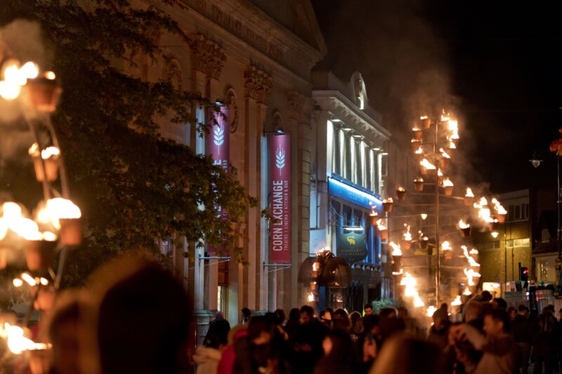 An image of the exterior of the Newbury Corn Exchange showing helixes of fire created by Compagnie Carabosse in the 101 outdoor arts event, Fire Garden