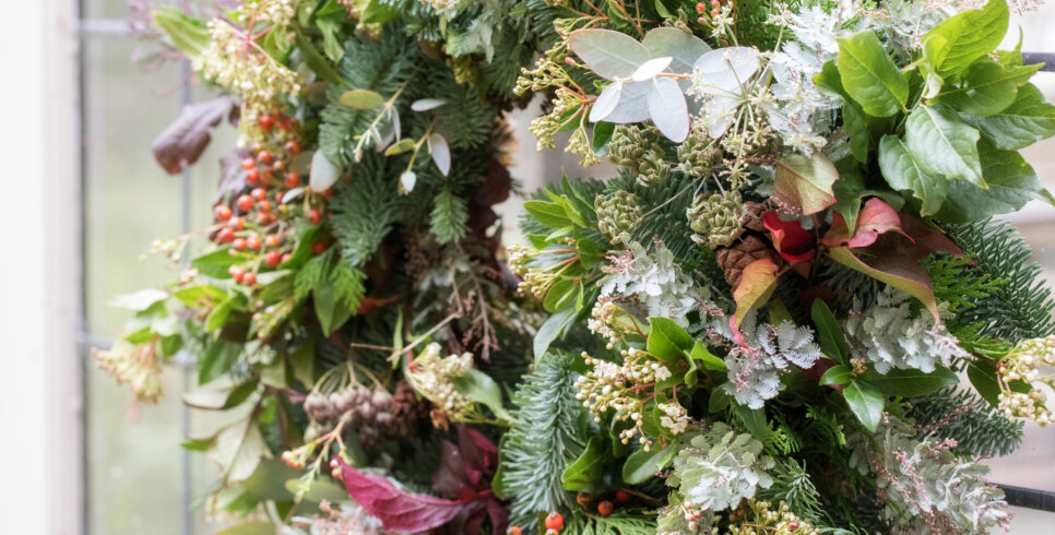 An up close image of Christmas Wreath with flowers.