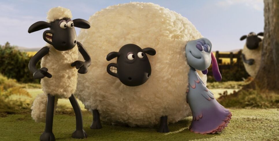 Shaun the sheep is stood next to a round sheep in a field where they are both looking at an blue and purple alien sheep.